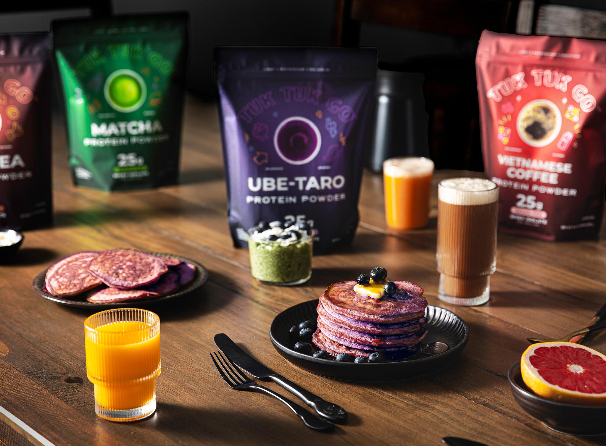 Full lineup of product pouches on table with breakfast foods.