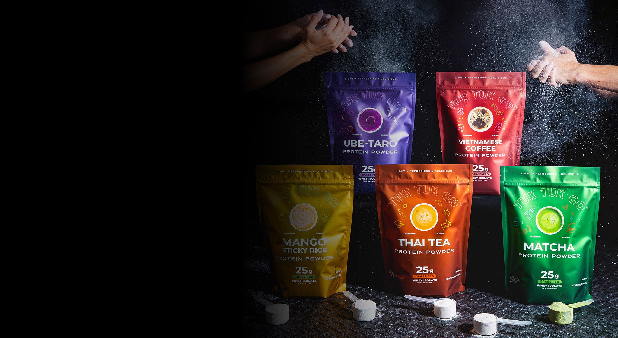 All five protein powder pouches on gym floor with hand clapping chalk over them