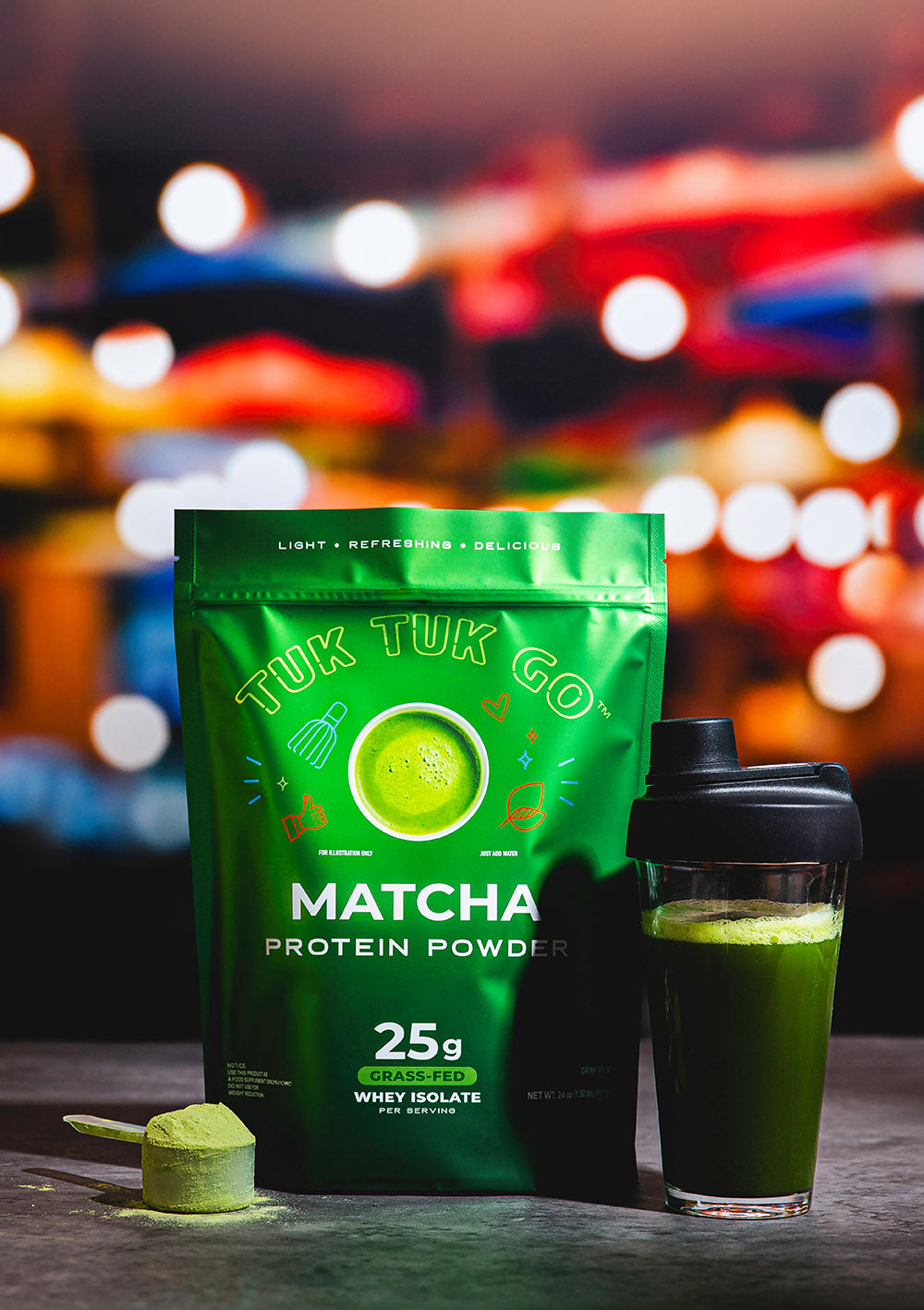 Matcha protein powder in pouch with mixed protein drink in glass.