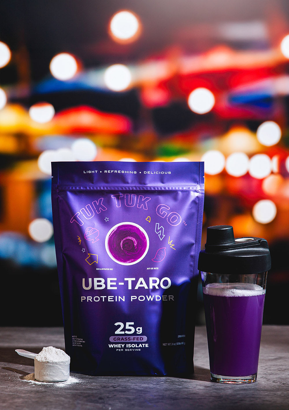 Ube Taro protein powder in pouch with mixed protein drink in glass.