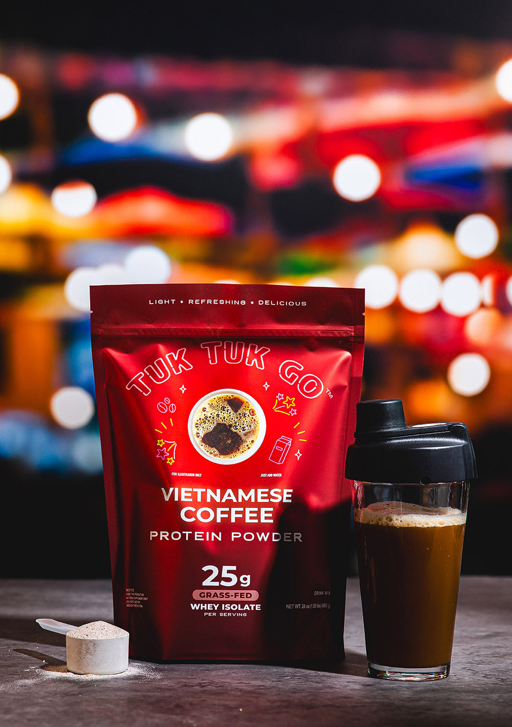 Vietnamese Coffee protein powder in pouch with mixed protein drink in glass.